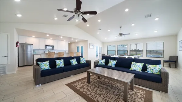 an aerial view of a houses with ocean view