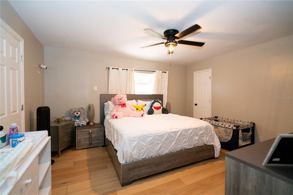 3102 Williams Road Brandon, FL 33510 - Photo 14 of 29 a bedroom with a bed and a chandelier