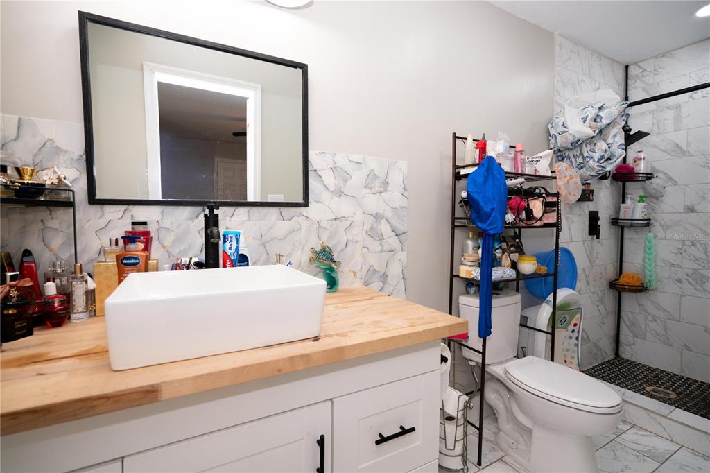 3102 Williams Road Brandon, FL 33510 - Photo 16 of 29 a bathroom with a sink toilet vanity and mirror