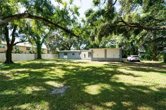 a swimming pool with outdoor seating and yard