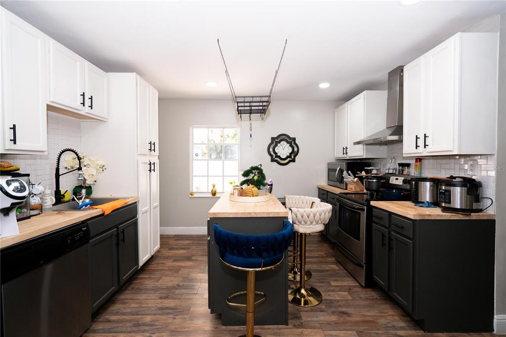 3102 Williams Road Brandon, FL 33510 - Photo 9 of 29 a kitchen with sink stove and cabinets