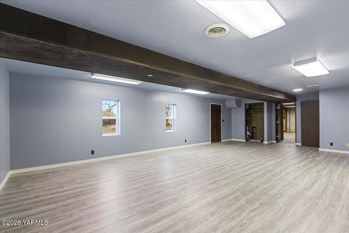1861 North Cottonwood Road Yakima, WA 98908 - Photo 22 of 35 a view of an empty room with wooden floor and a window