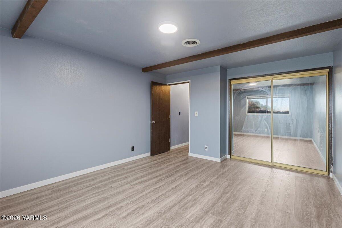 1861 North Cottonwood Road Yakima, WA 98908 - Photo 24 of 35 an empty room with wooden floor and mirror