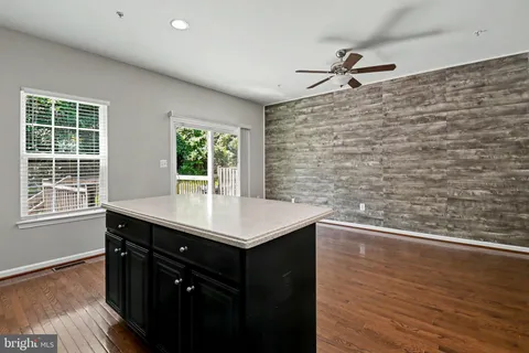 a kitchen with a sink cabinets and wooden floor