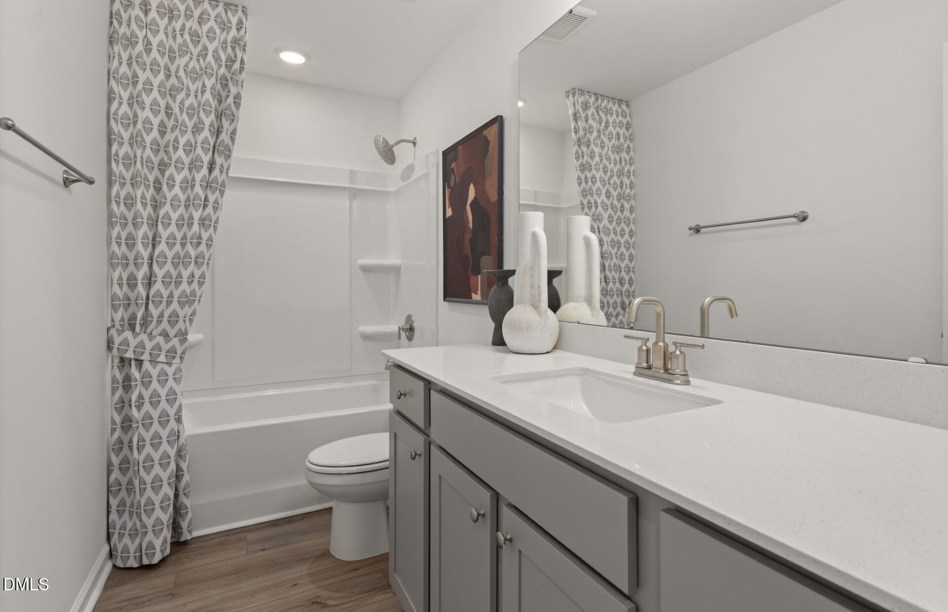605 Timber Terrace Drive Durham, NC 27704 - Photo 11 of 31 a bathroom with a double vanity sink toilet and shower