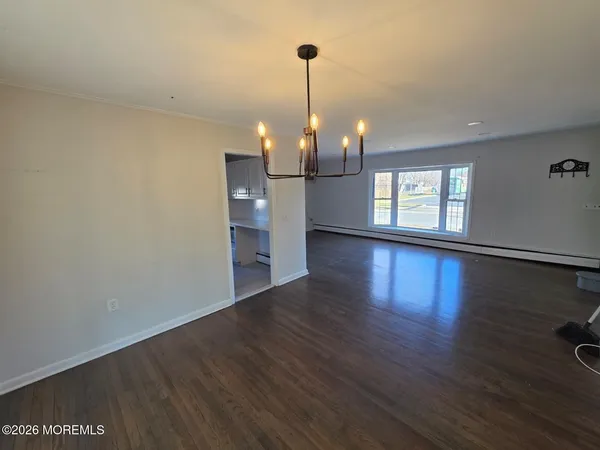 a view of a room with wooden floor and window