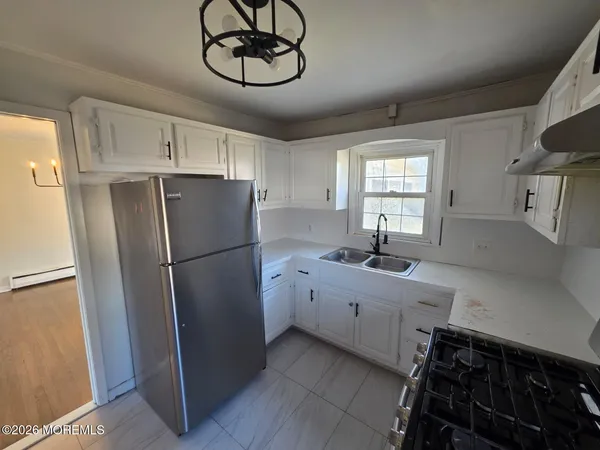 a kitchen with a refrigerator and a sink