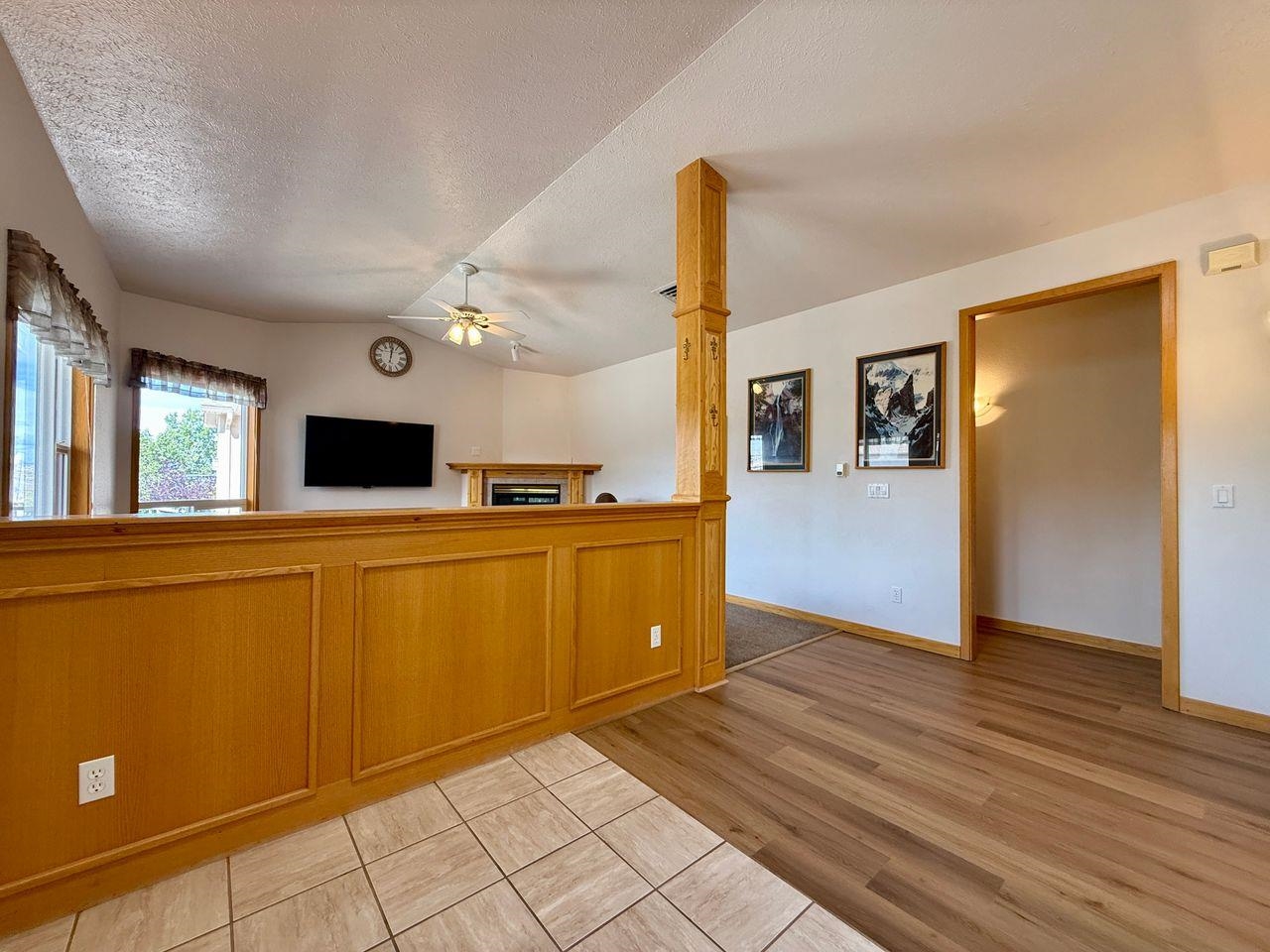 920 Crown Court Fruita, CO 81521 - Photo 12 of 42 a view of a kitchen with wooden floor and a refrigerator
