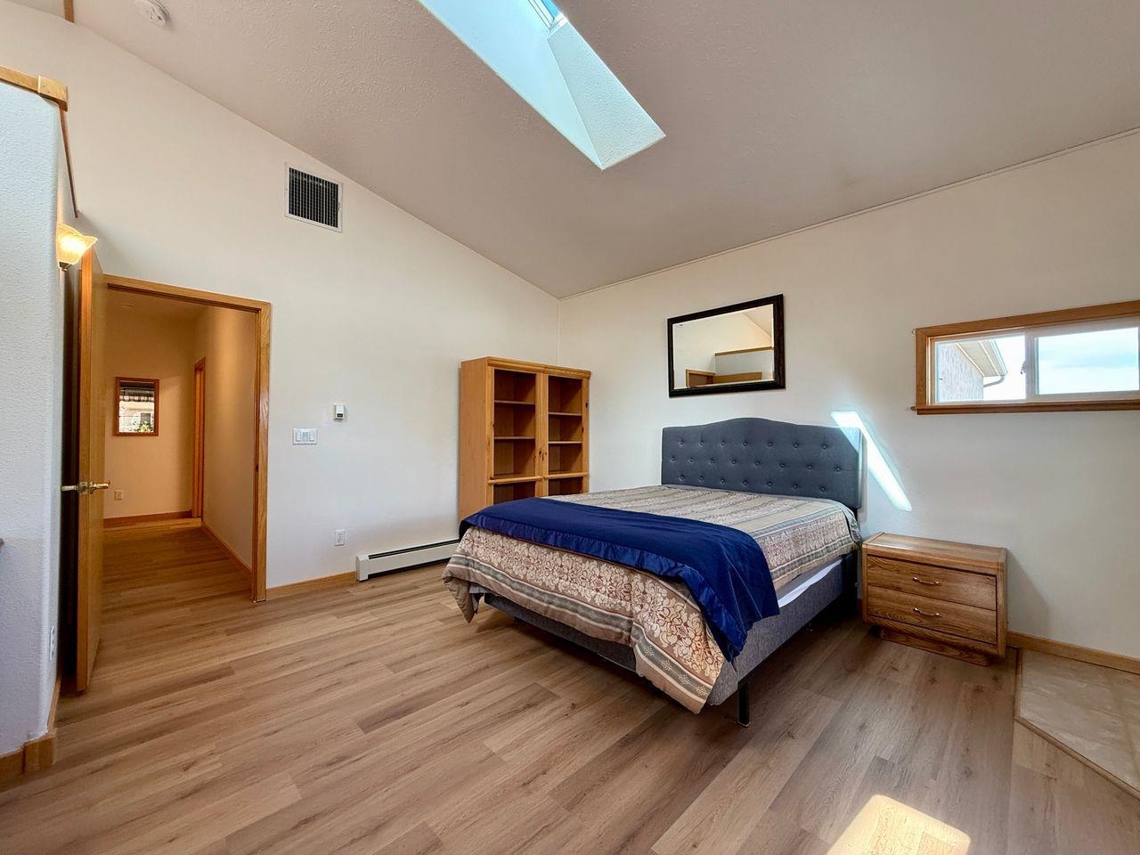 920 Crown Court Fruita, CO 81521 - Photo 16 of 42 a bedroom with a bed and wooden floor