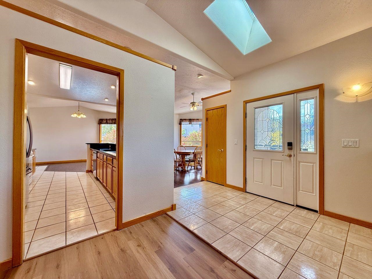 920 Crown Court Fruita, CO 81521 - Photo 2 of 42 a view of a hallway with wooden floor and a livingroom