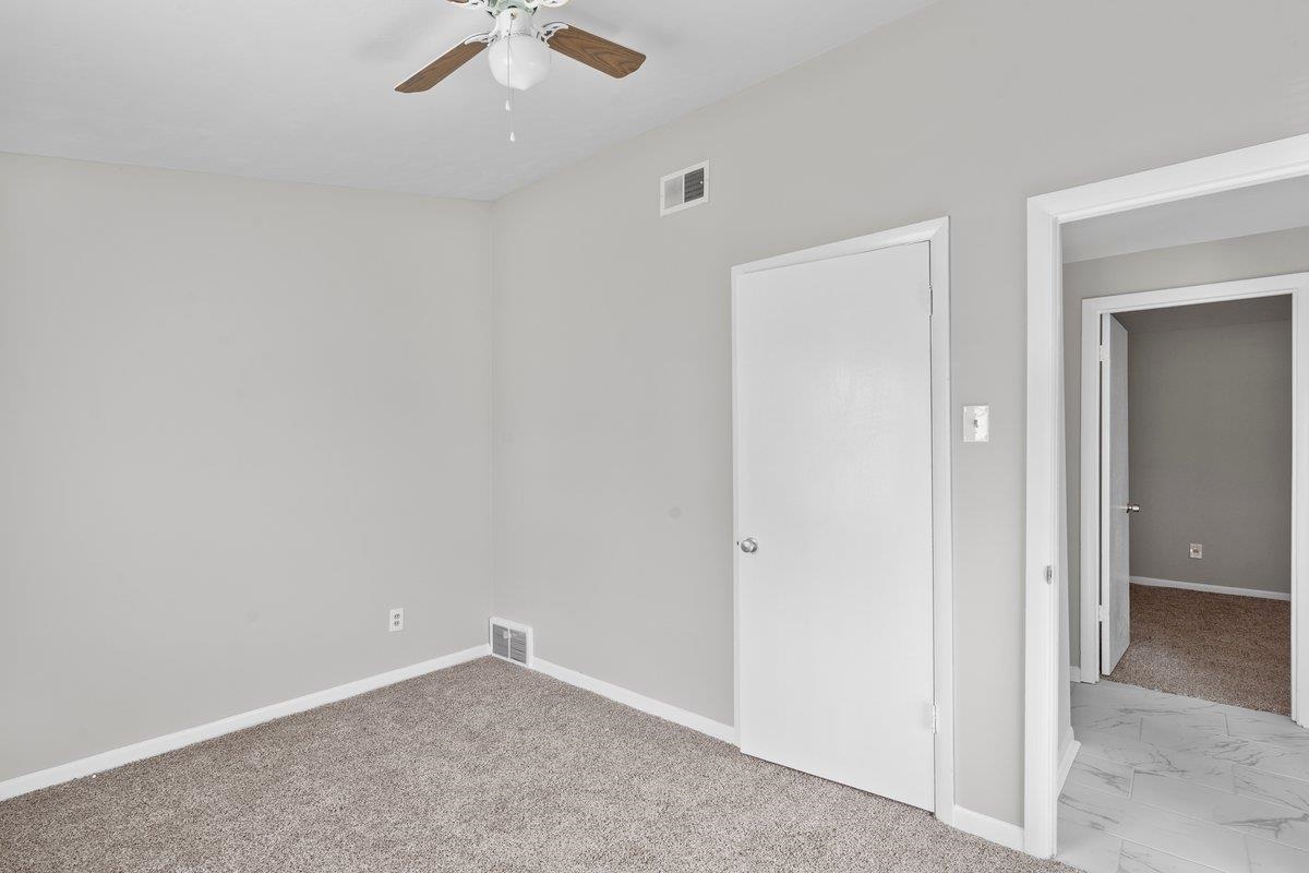 4948 Knight Arnold Road Memphis, TN 38118 - Photo 12 of 27 Unfurnished bedroom featuring light carpet and ceiling fan