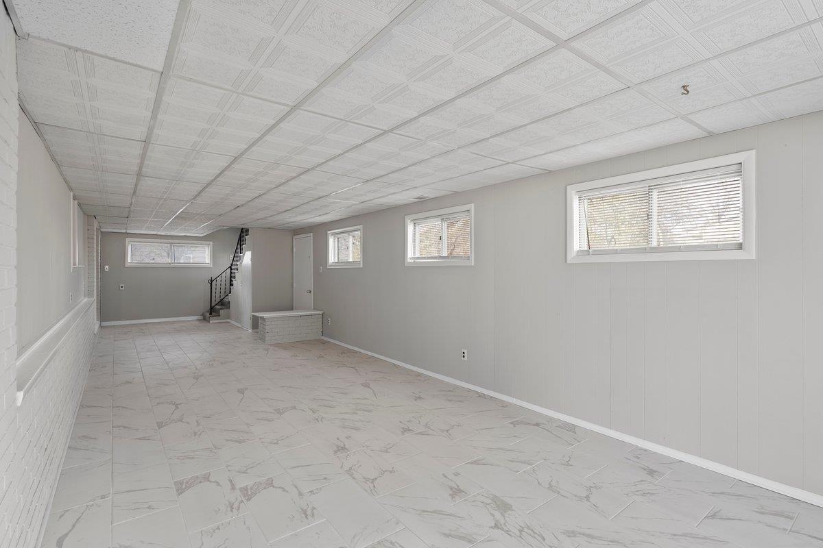 4948 Knight Arnold Road Memphis, TN 38118 - Photo 15 of 27 Basement with stairs and baseboards