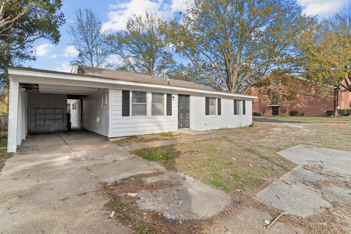 4948 Knight Arnold Road Memphis, TN 38118 - Photo 26 of 27 Single story home with driveway, a carport, roof with shingles, and brick siding