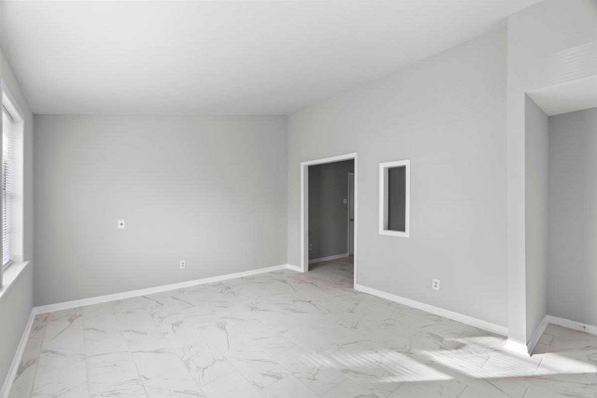 4948 Knight Arnold Road Memphis, TN 38118 - Photo 4 of 27 Spare room featuring baseboards and light marble finish floors