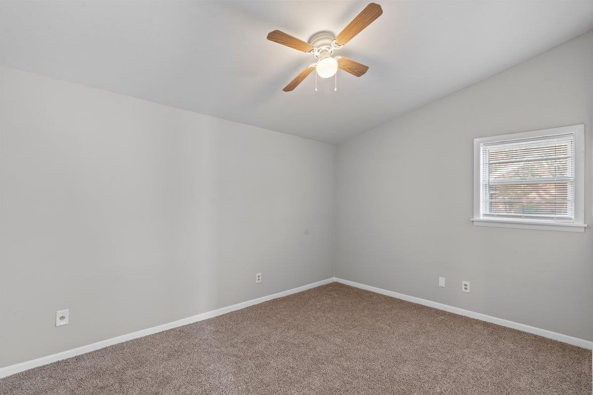 4948 Knight Arnold Road Memphis, TN 38118 - Photo 7 of 27 Carpeted spare room with lofted ceiling and a ceiling fan