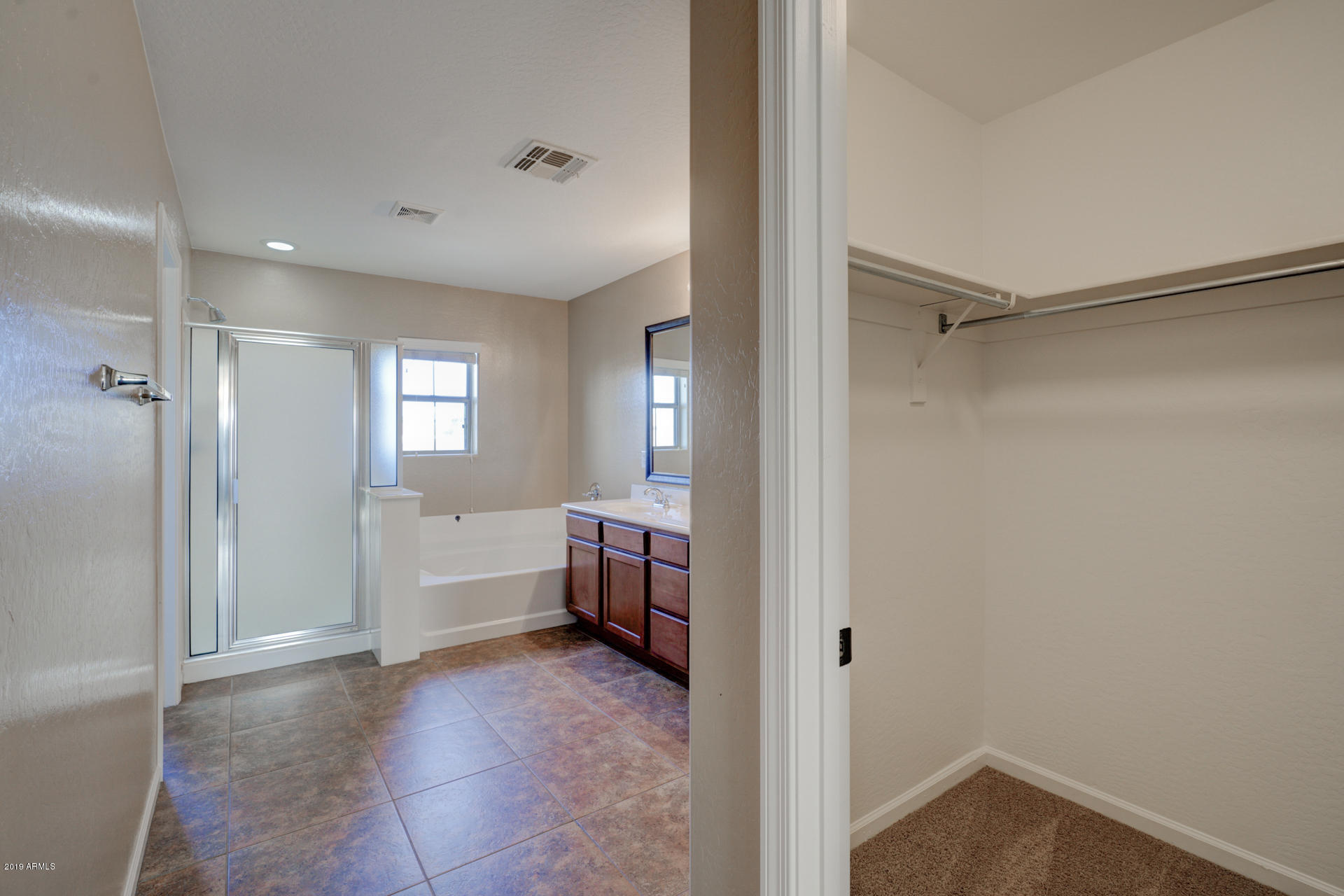 1891 South Racine Lane Gilbert, AZ 85295 - Photo 15 of 35 a bathroom with a bathtub and shower