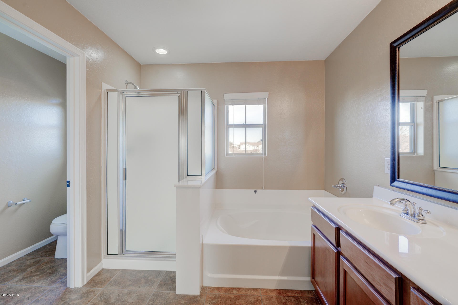 1891 South Racine Lane Gilbert, AZ 85295 - Photo 18 of 35 a bathroom with a tub sink and a mirror