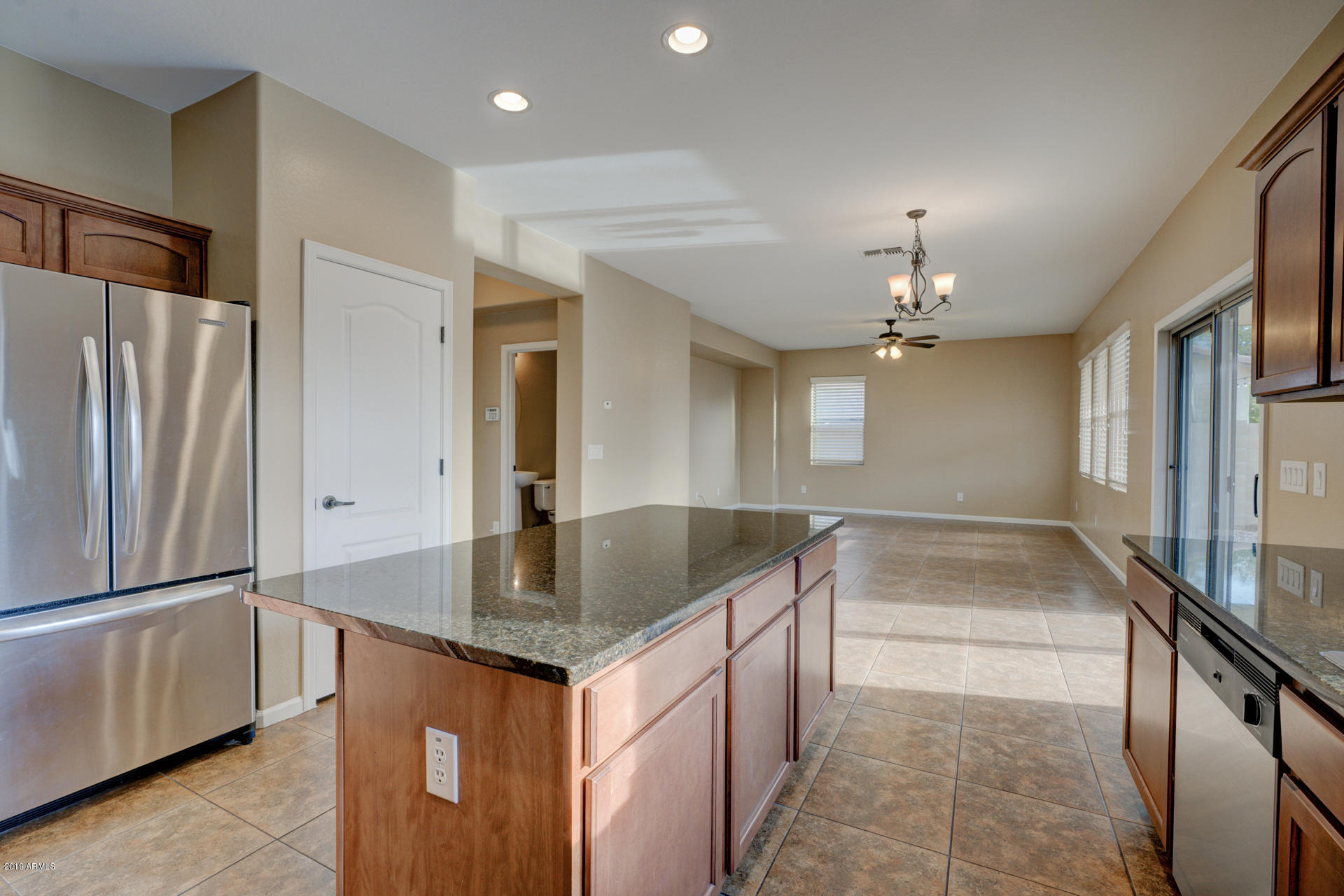 1891 South Racine Lane Gilbert, AZ 85295 - Photo 8 of 35 a kitchen with stainless steel appliances granite countertop a sink and a refrigerator