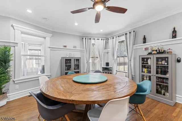 a dining room with furniture and wooden floor