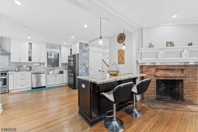 a view of kitchen with cabinets and wooden floor