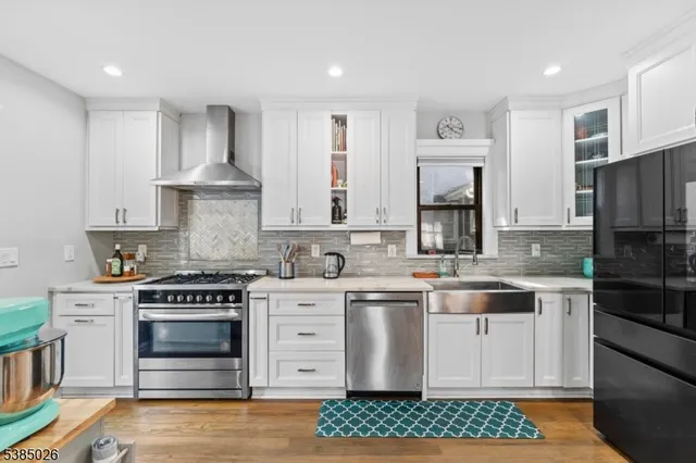 a kitchen with stainless steel appliances a stove sink and cabinets
