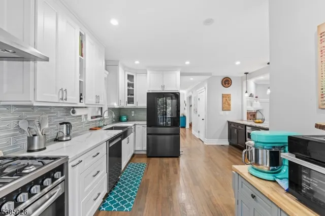a kitchen with a sink stainless steel appliances and cabinets