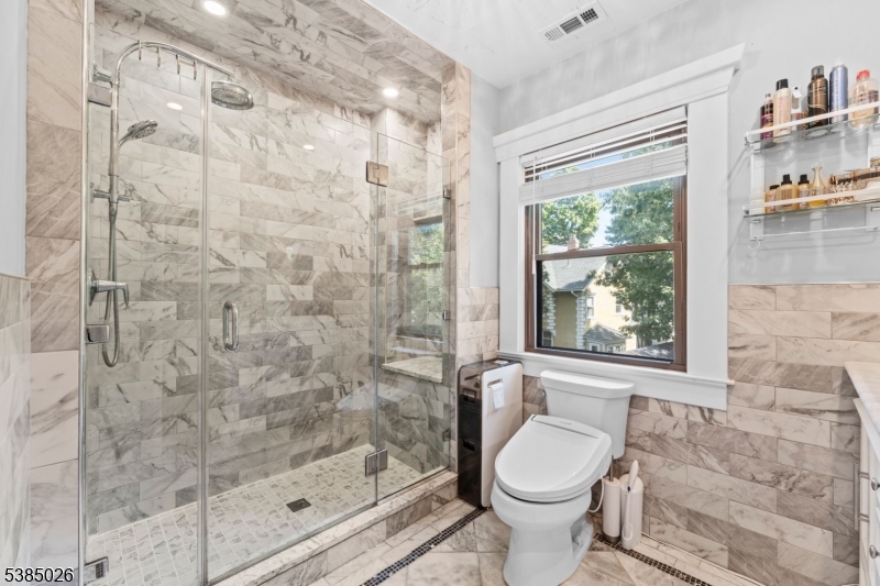 283 Orange Road Montclair, NJ 07042 - Photo 24 of 41 a bathroom with a granite countertop toilet a sink and a shower