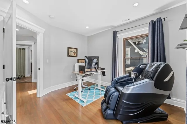 a work room with furniture and wooden floor