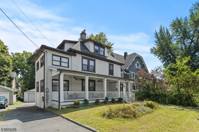 a view of a white house with a swimming pool