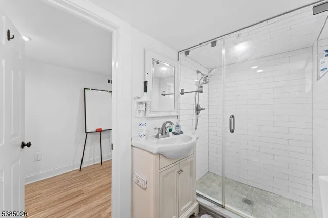 a bathroom with a sink mirror and shower