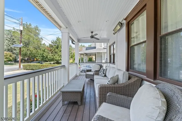 a balcony with furniture and a potted plant