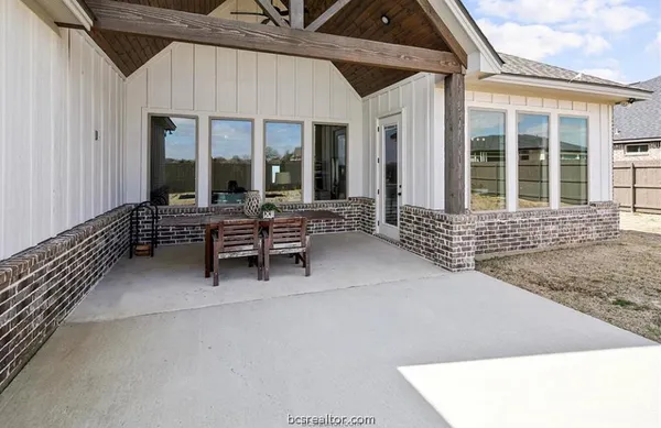 a balcony with furniture and large window