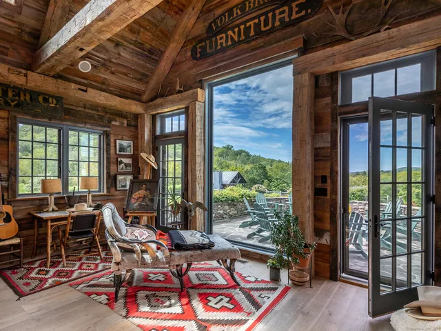 a living room with furniture and large windows