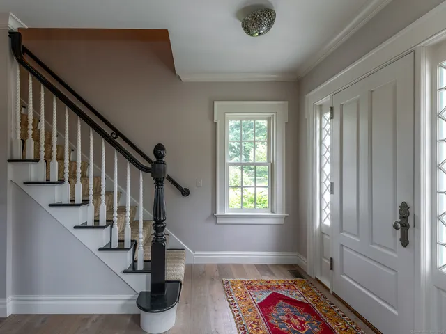 a view of hallway with windows and stairs