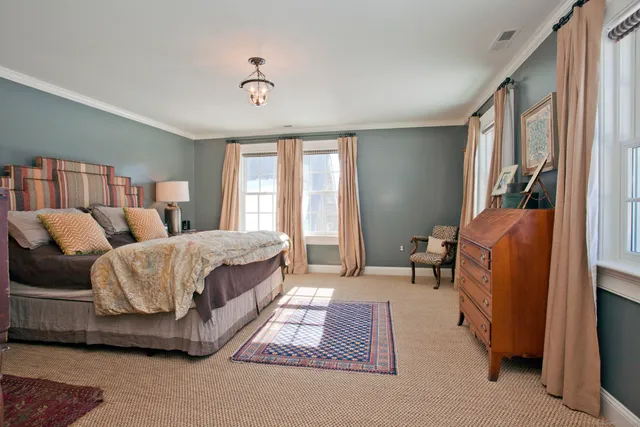 a spacious bedroom with a bed and a window