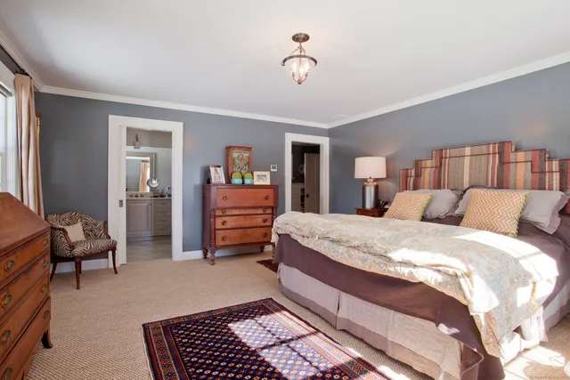 a bed room with a bed and a chair