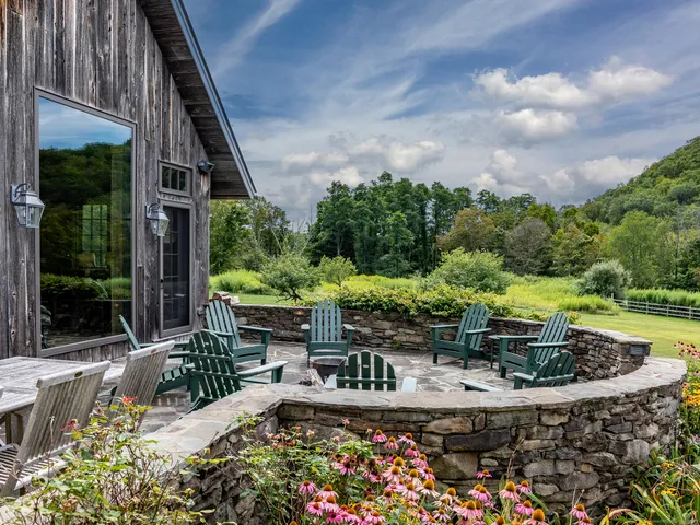 a view of a backyard with sitting area