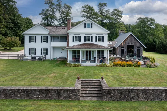 a front view of a house with a yard table and chairs