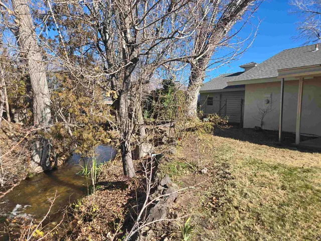 a view of a house with a yard covered in snow