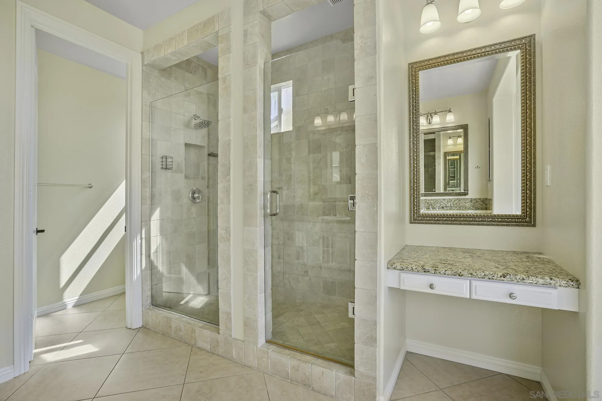 7065 Crystalline Drive Carlsbad, CA 92011 - Photo 16 of 26 a bathroom with a granite countertop sink mirror and shower