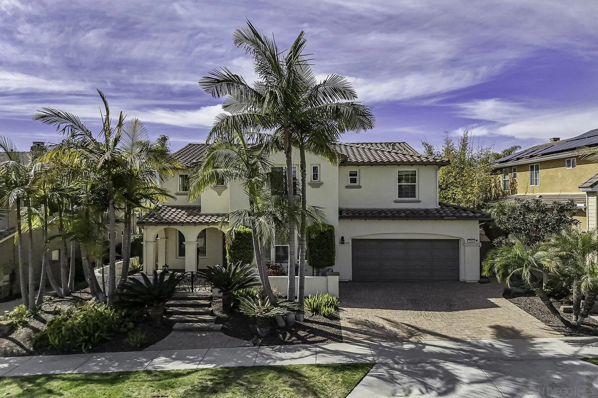 7065 Crystalline Drive Carlsbad, CA 92011 - Photo 24 of 26 a front view of a house with yard garage and outdoor seating