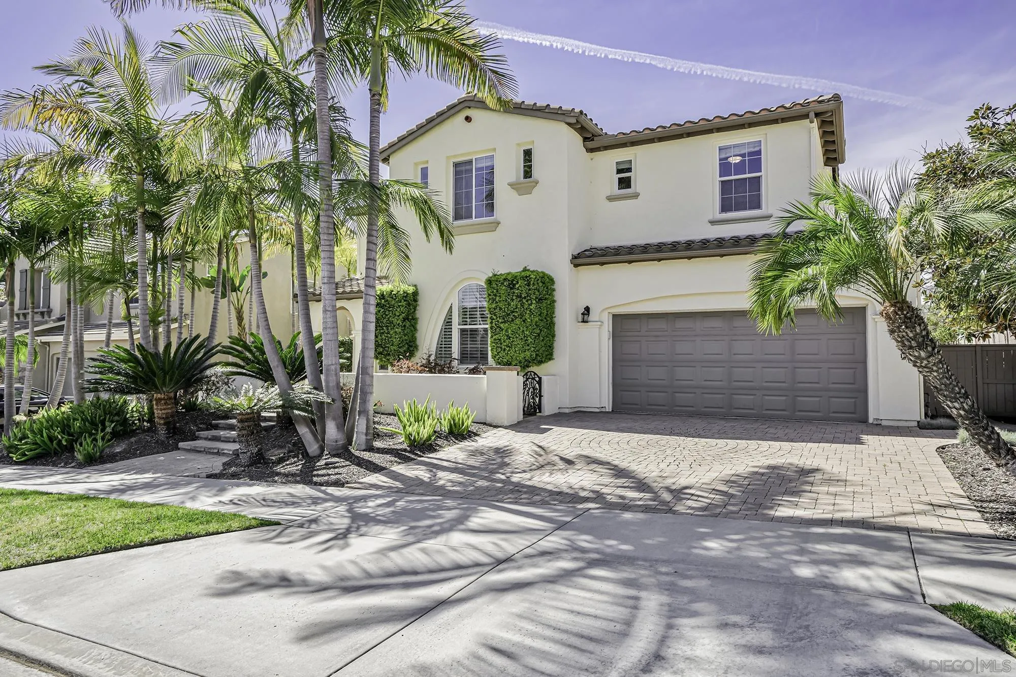 7065 Crystalline Drive Carlsbad, CA 92011 - Photo 25 of 26 a front view of a house with a yard and garage