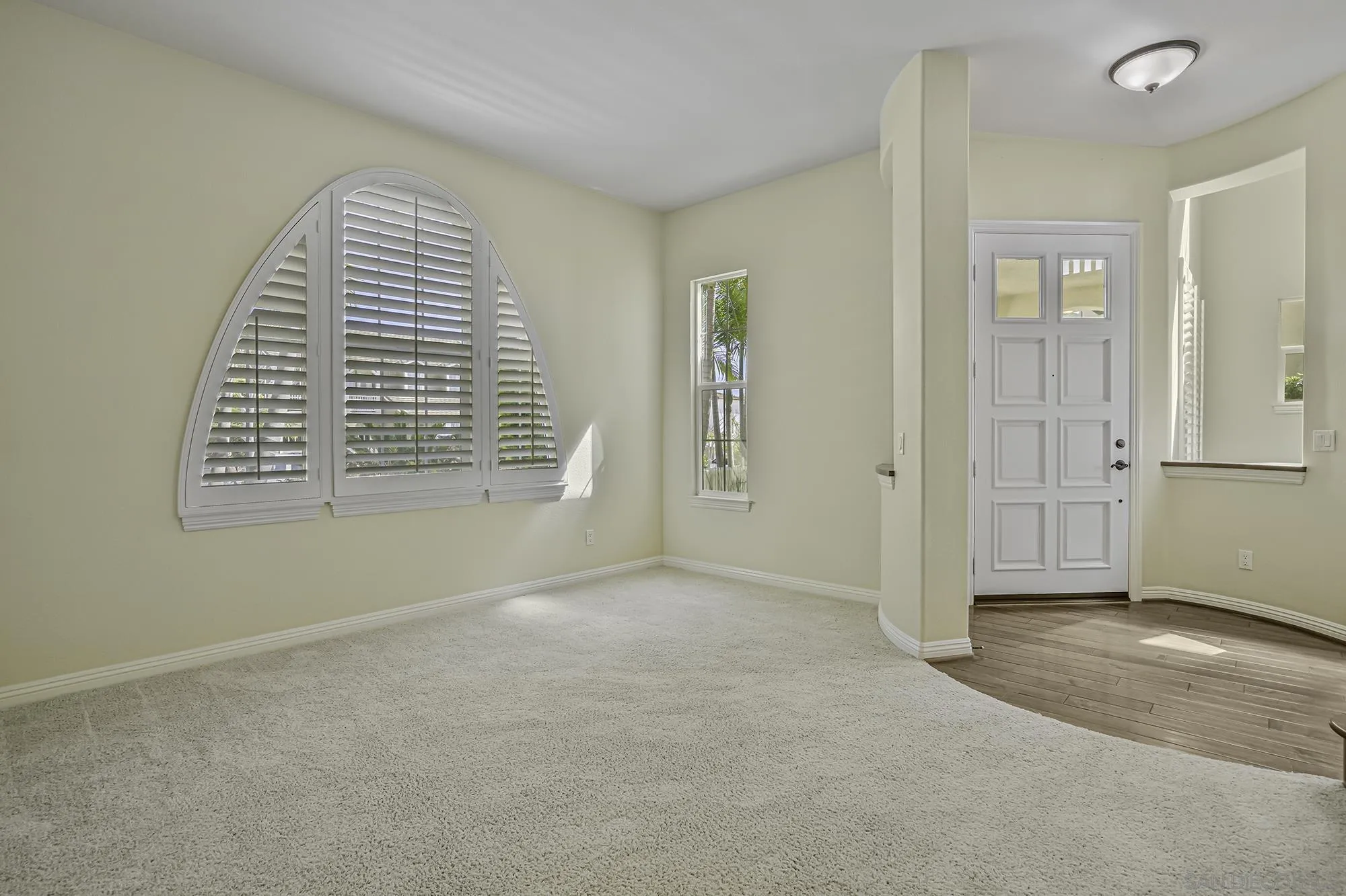 7065 Crystalline Drive Carlsbad, CA 92011 - Photo 5 of 26 an empty room with windows