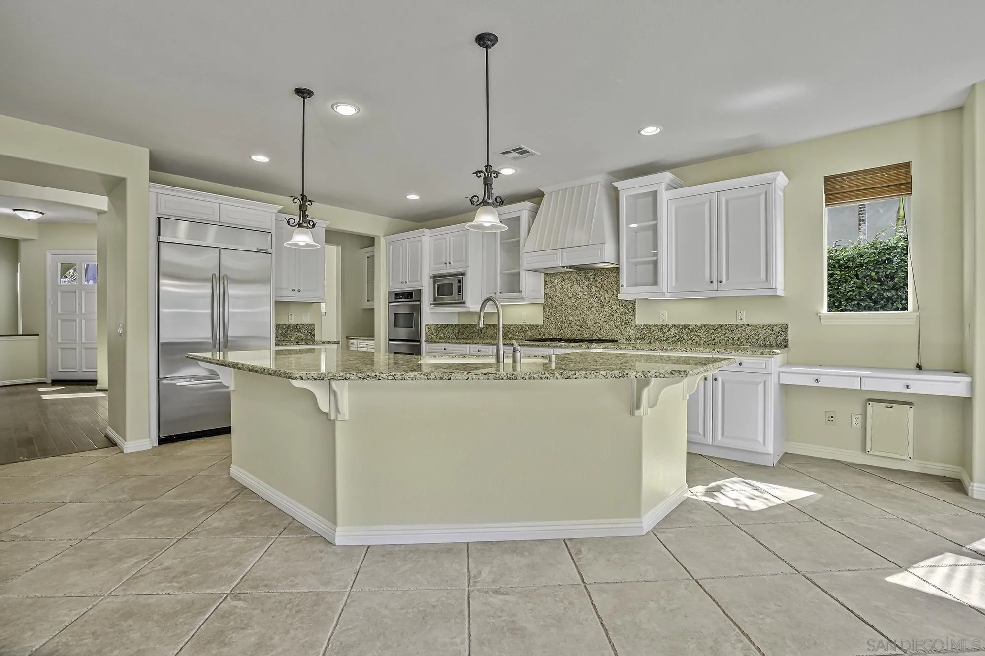 7065 Crystalline Drive Carlsbad, CA 92011 - Photo 8 of 26 a large kitchen with kitchen island a sink a counter top stainless steel appliances and cabinets