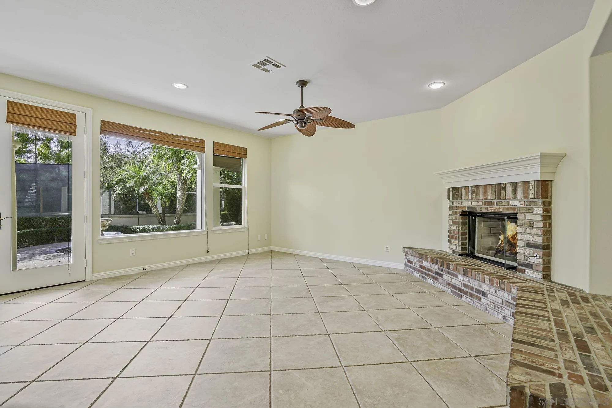 7065 Crystalline Drive Carlsbad, CA 92011 - Photo 9 of 26 a view of an empty room with a fireplace and a window