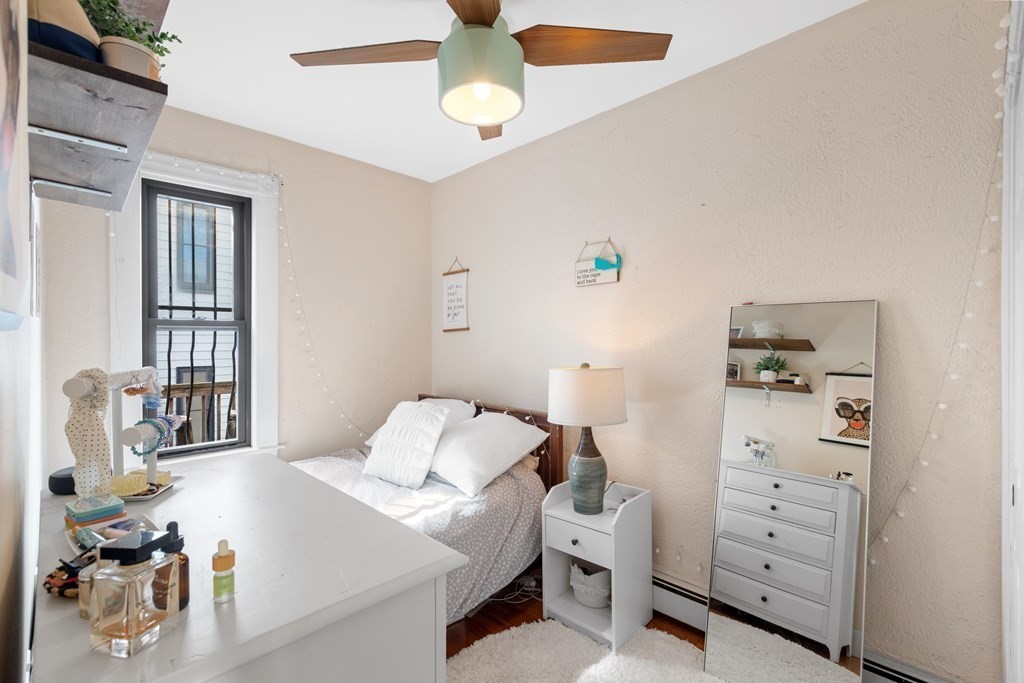 217 Boylston Street, Unit 3 Boston, MA 02130 - Photo 13 of 18 a bedroom with a bed and a dresser