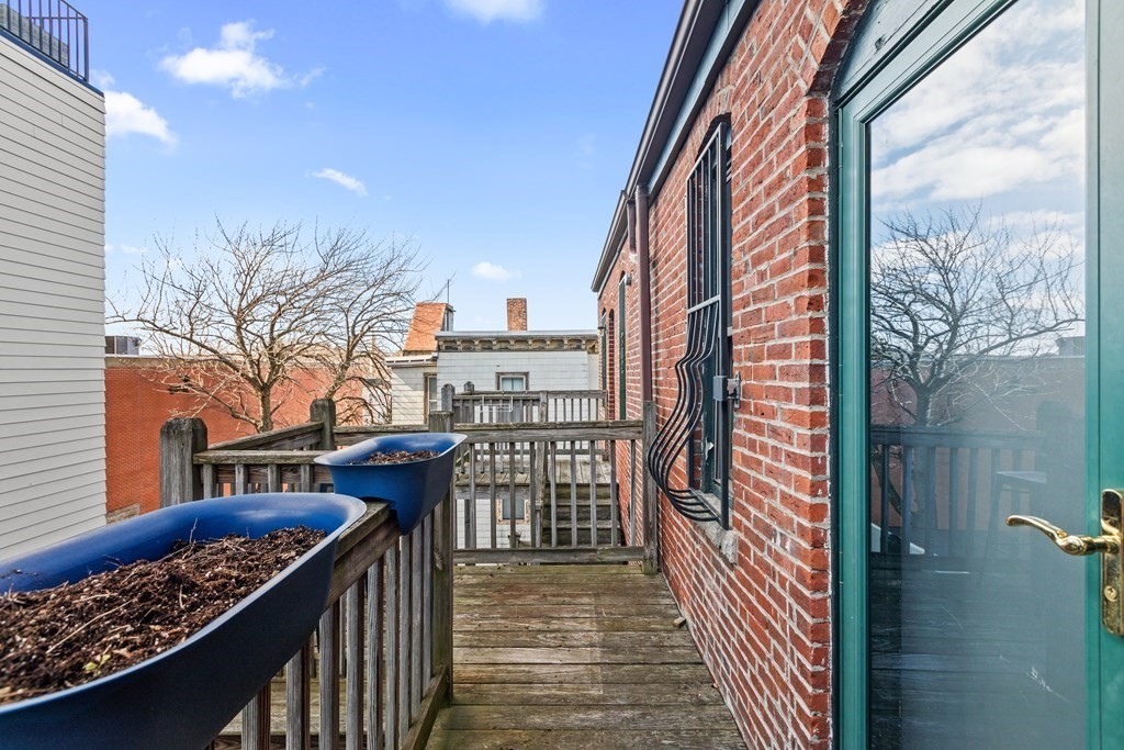217 Boylston Street, Unit 3 Boston, MA 02130 - Photo 15 of 18 a view of a balcony with wooden fence and floor