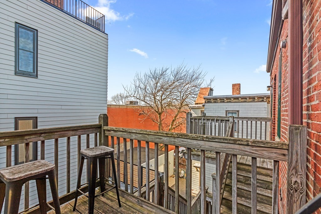 217 Boylston Street, Unit 3 Boston, MA 02130 - Photo 16 of 18 a view of a balcony with wooden floor and fence