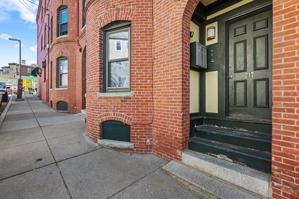 217 Boylston Street, Unit 3 Boston, MA 02130 - Photo 2 of 18 a view of a brick house with many windows