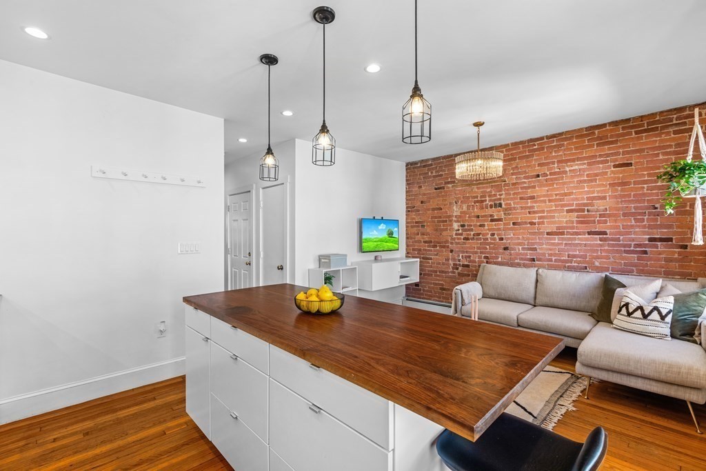 217 Boylston Street, Unit 3 Boston, MA 02130 - Photo 8 of 18 a living room with furniture and wooden floor